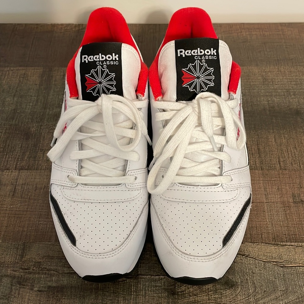 White, red, and black leather Reebok sneakers. Size 8.5